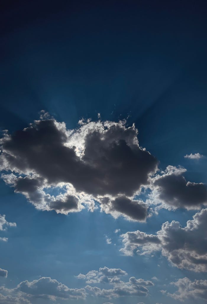 Sunlight beams through clouds creating a stunning, dramatic sky scene.